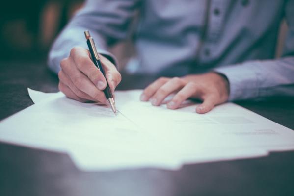 Person signing a document.